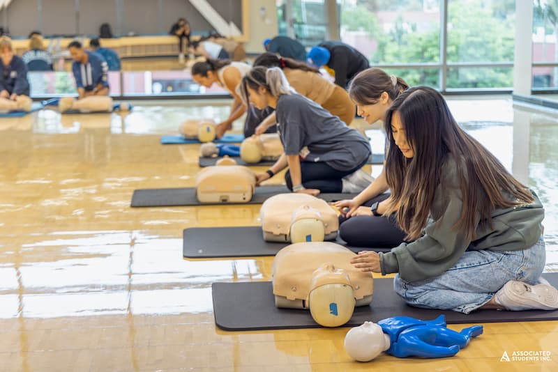 students performing cpr